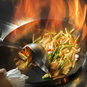 中華鍋で料理をしている